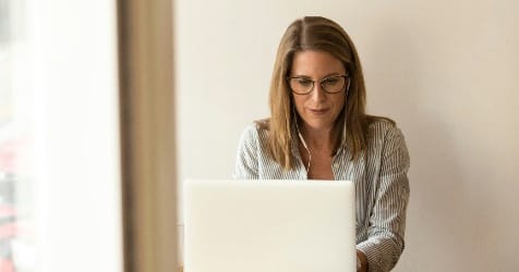 woman typing on laptop